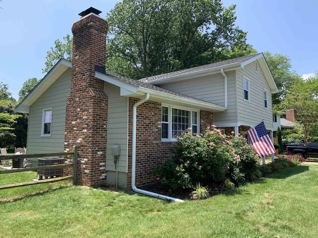 Gray composite siding with white trim on craftsman style home